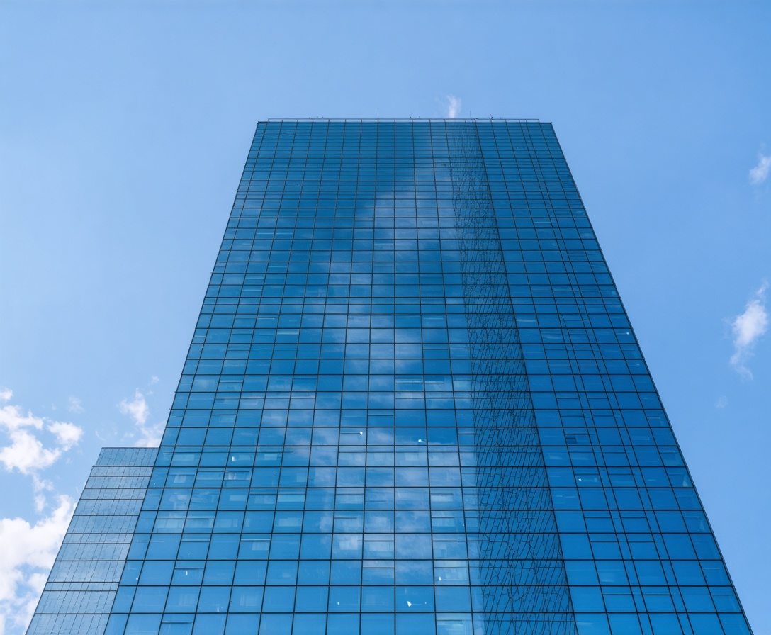 Minimalist modern skyscraper with glass reflections representing financial growth